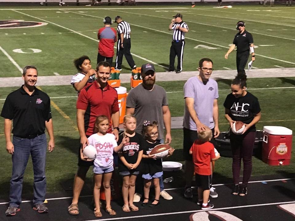 The Active Health Clinics team with young athletes at a Fort Dodge football game