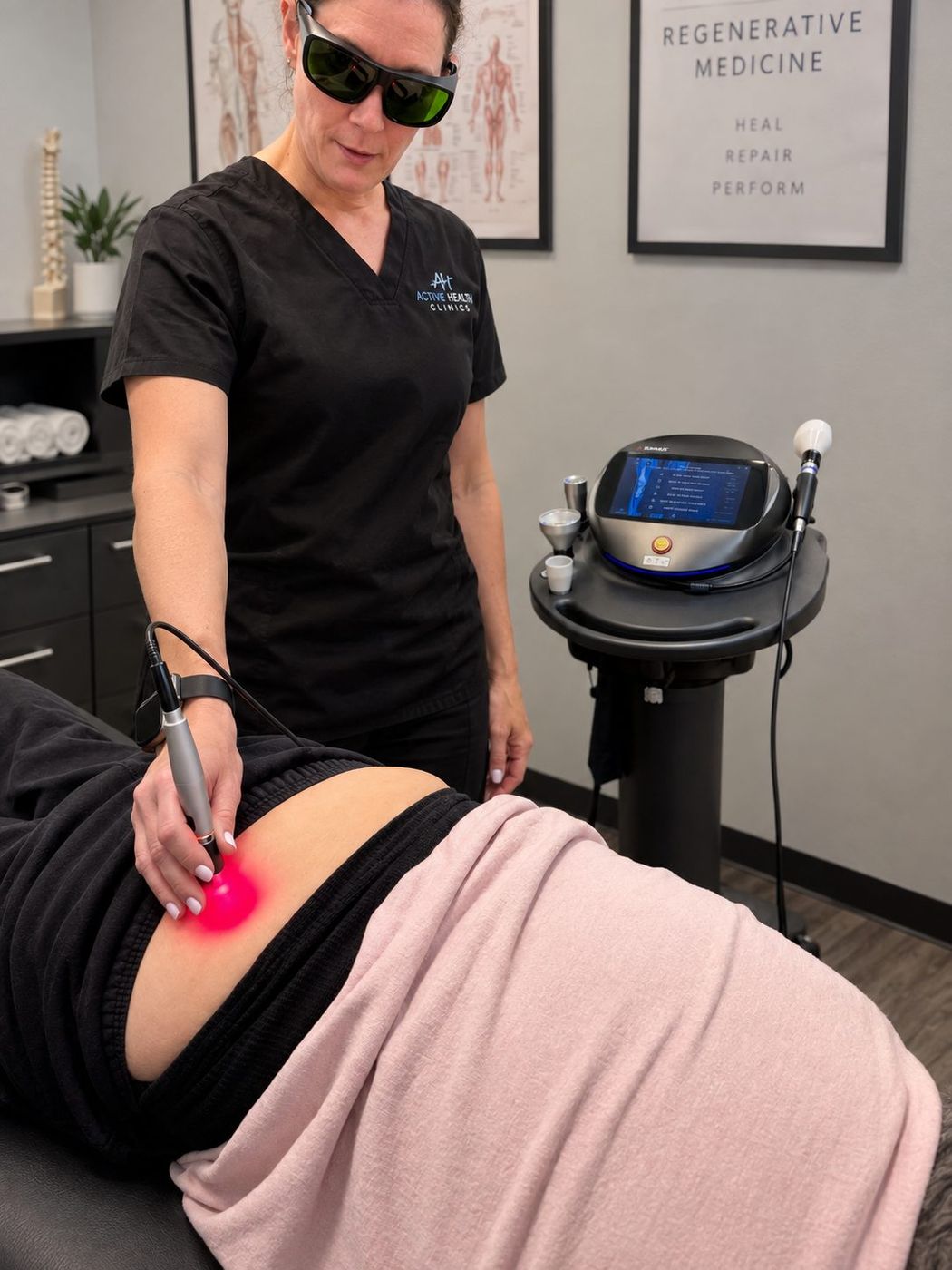 Laser therapy on a patient's lower back at Active Health Clinics