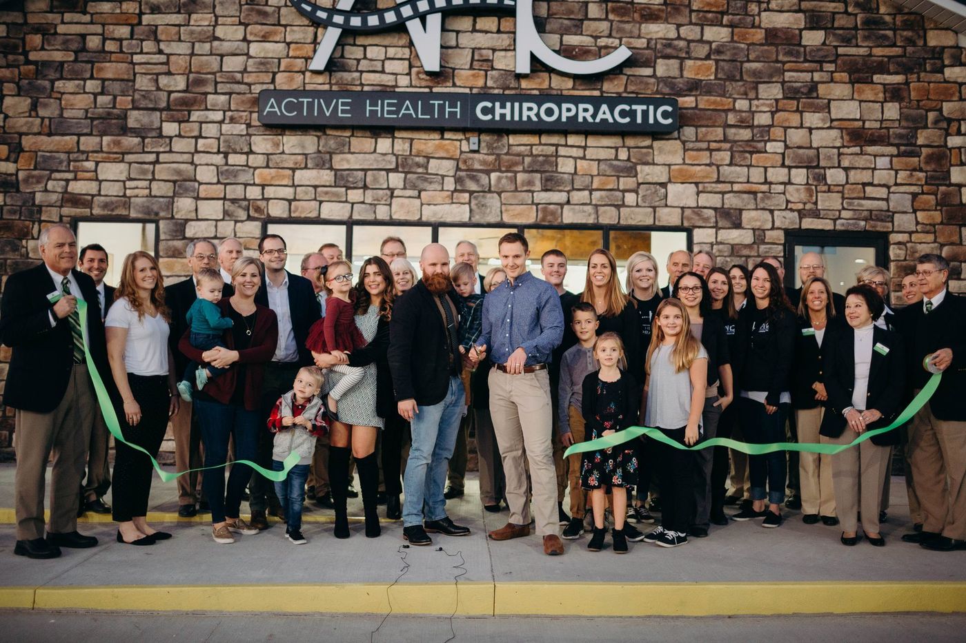 Ribbon cutting at the Active Health Clinics building with community members